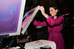 FORT BELVOIR, VA - FEBRUARY 6: Actress Olivia Munn silkscreens t-shirts for military members and their families at the launch event for Jeep Operation Safe Return at the USO Warrior & Family Center on February 6, 2013 in Fort Belvoir, Virginia.  (Photo by Brendan Hoffman/Getty Images for Jeep)