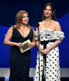 SANTA MONICA, CA - JANUARY 13:  Justina Machado (L) and Olivia Munn speak onstage during the 24th annual Critics' Choice Awards at Barker Hangar on January 13, 2019 in Santa Monica, California.  (Photo by Kevin Winter/Getty Images for The Critics' Choice Awards)