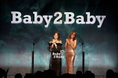 WEST HOLLYWOOD, CALIFORNIA - NOVEMBER 08: (L-R) Olivia Munn and Kerry Washington speak onstage during the 2025 Baby2Baby Gala Presented By Paul Mitchell at Pacific Design Center on November 08, 2025 in West Hollywood, California. (Photo by Araya Doheny/Getty Images for Baby2Baby)